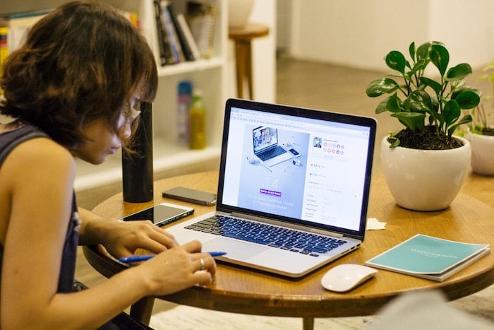 Photo of a woman in front of a computer, part on article on the most in-demand types of digital content for 2021