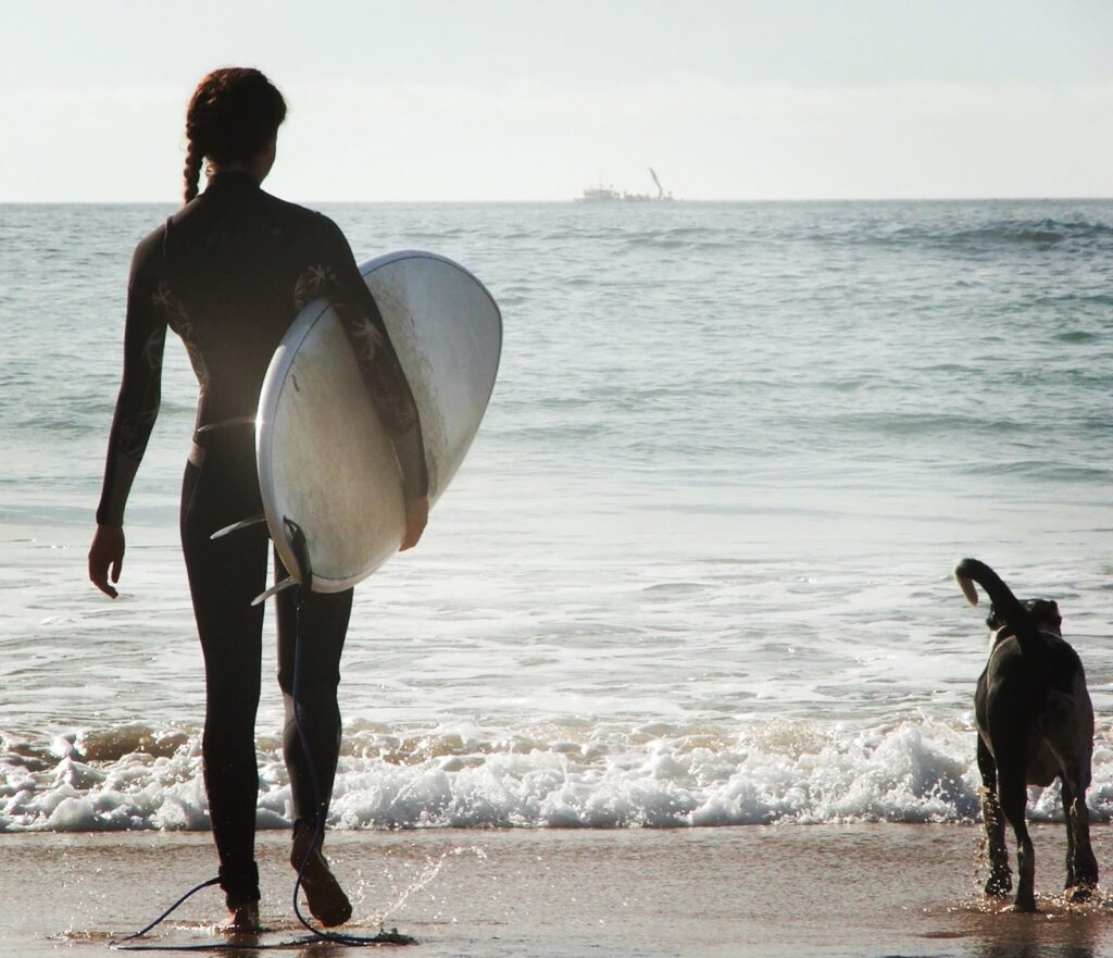 Melissa Haun heading into the waves on a surf trip in southern Portugal.