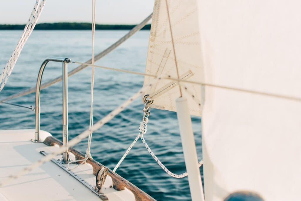 Image of a white sail on the blue sea