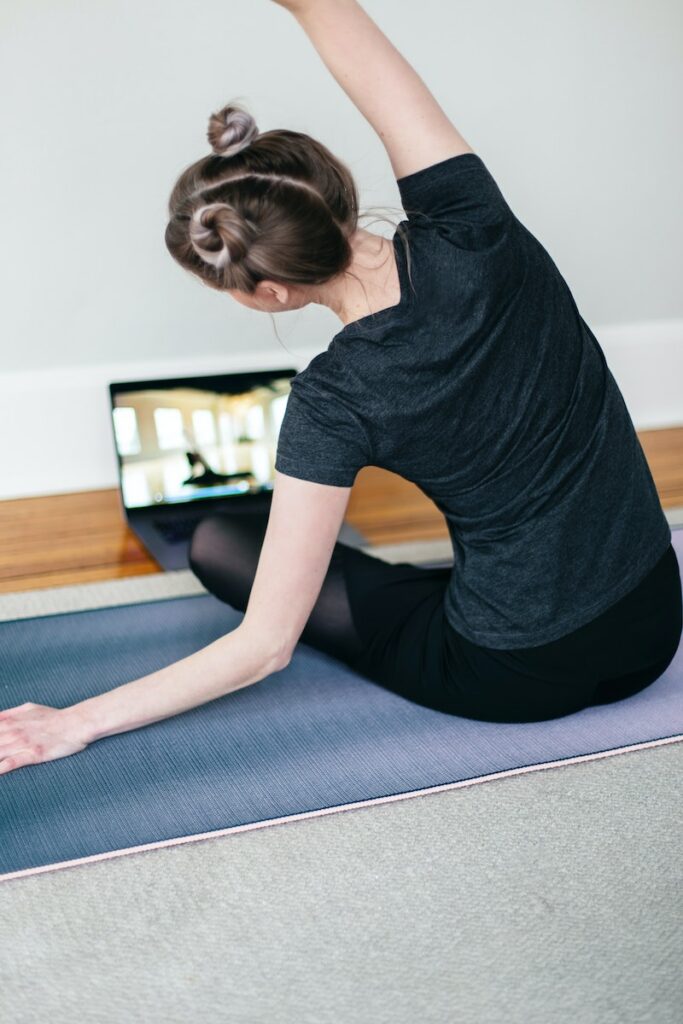 Woman doing an online yoga class at home