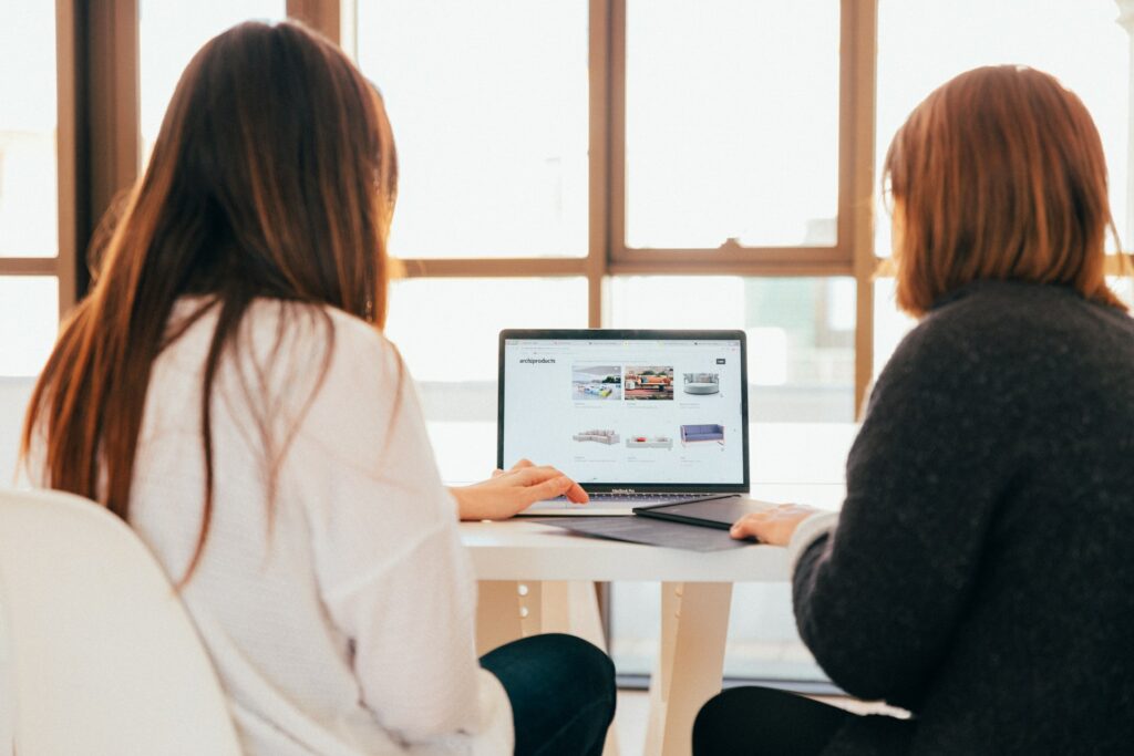 Two colleagues discussing their company's global marketing standardization strategy.