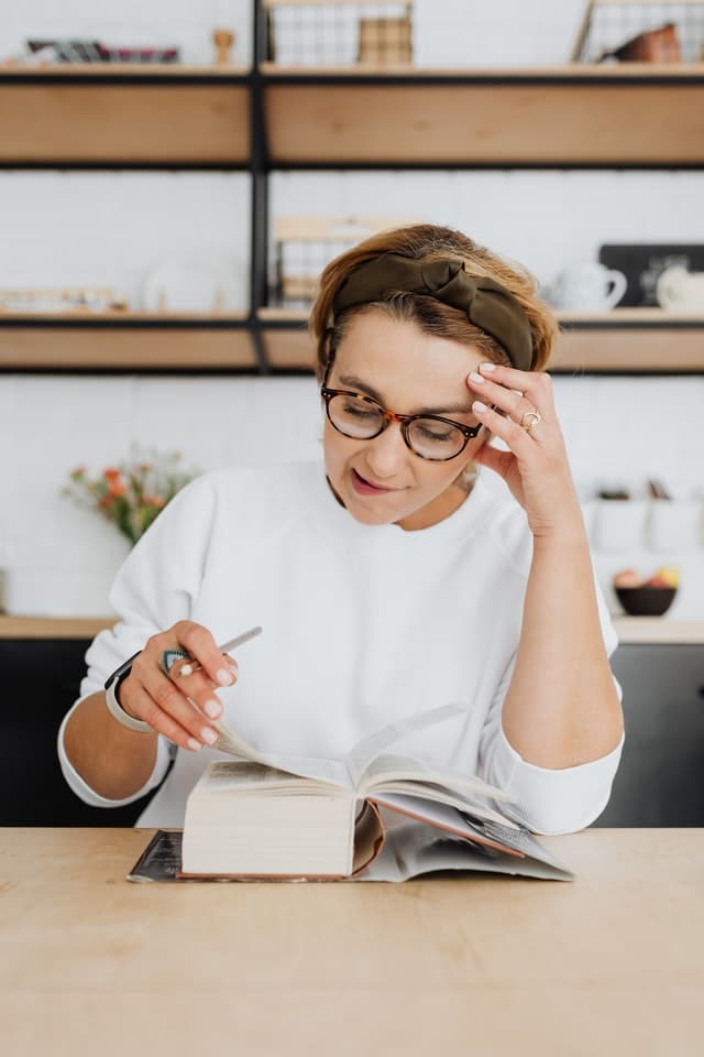 A marketing translator looking through a dictionary while translating