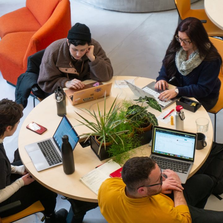 Professionals working on creative translations at a coworking space in Madrid