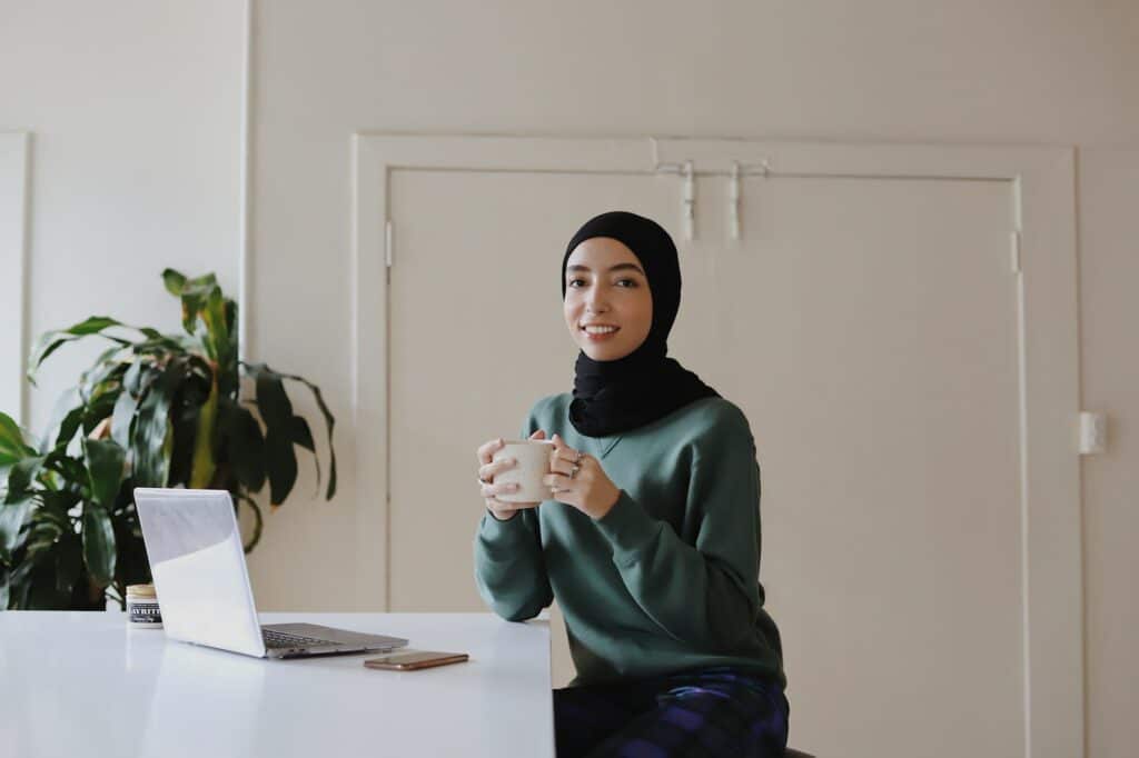 A woman wearing hijab at laptop representing the EMEA market