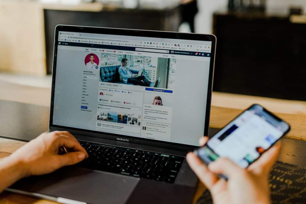 Laptop showing how to set up Facebook profile to post in multiple languages