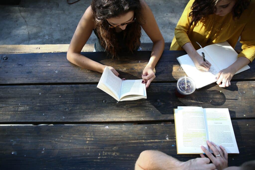 Women writing and reading while working on multilingual copywriting projects
