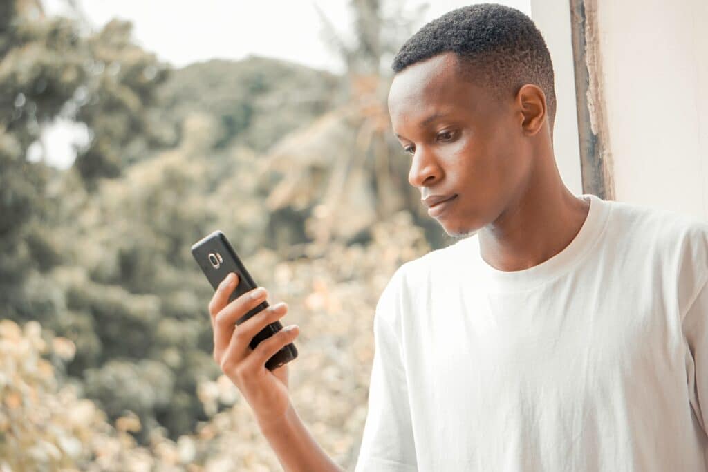 A man on iphone checking multilingual digital presence