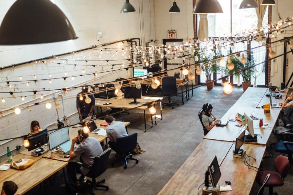 Top view of an office with people working on their laptops and computers