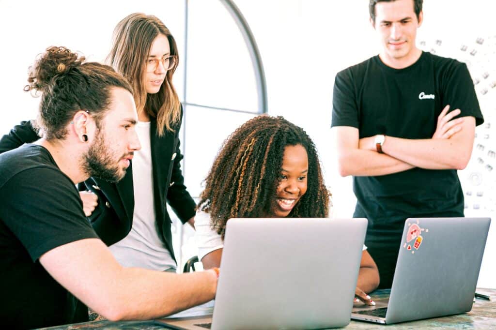 Four people at a work meeting discussing the best content management system