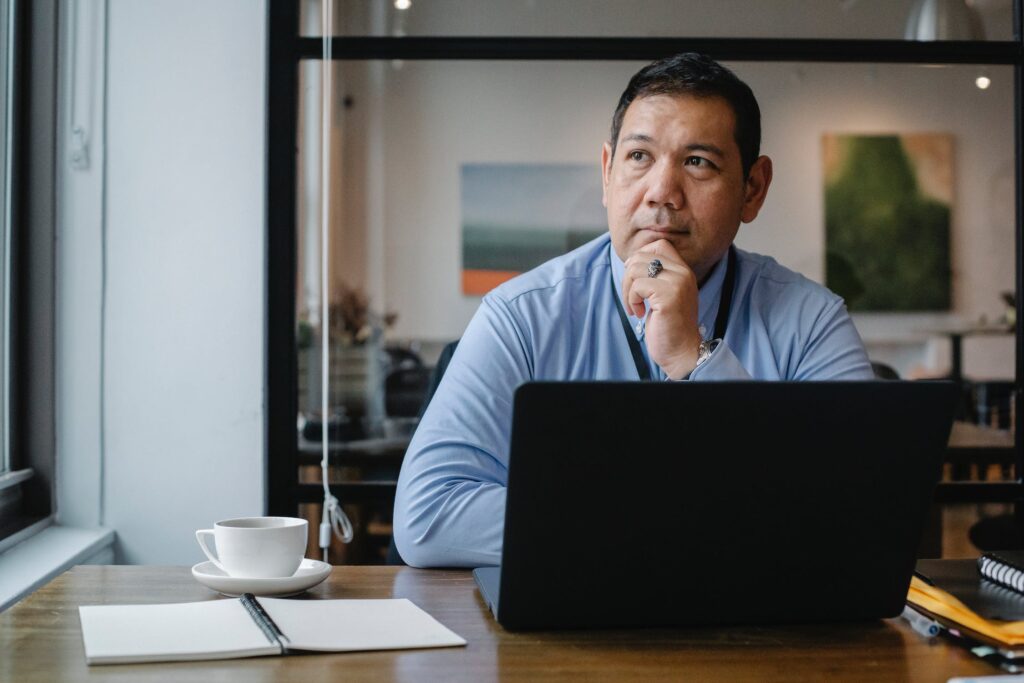 A global marketing specialist sitting behind his laptop