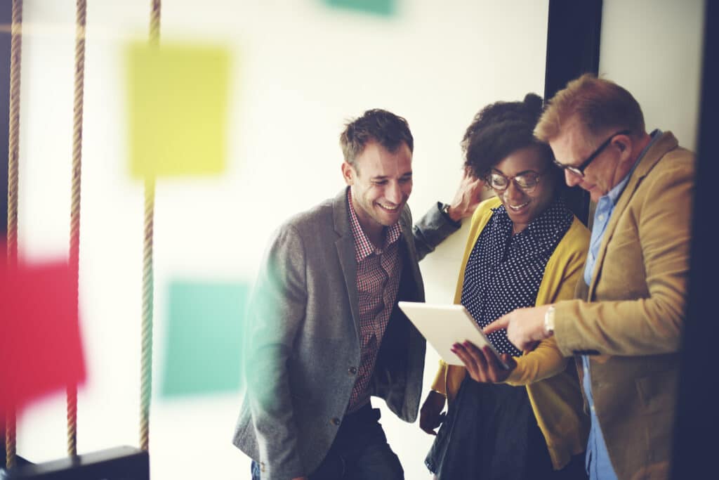 Marketing team discussing their global content strategy while looking at an iPad