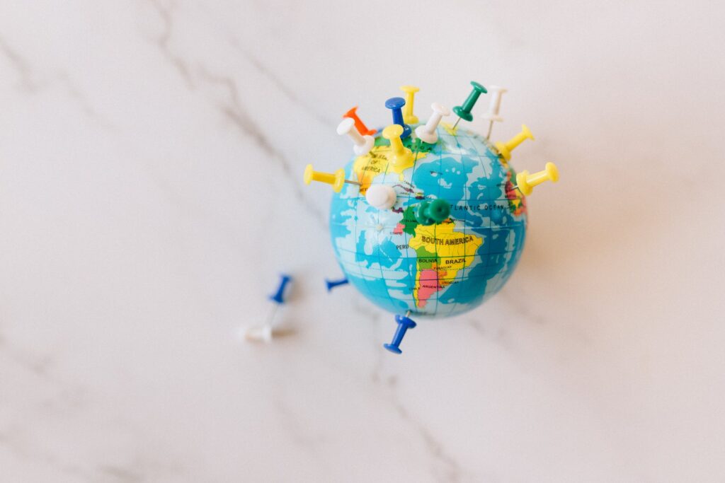 Push pins on a tiny globe showing South America