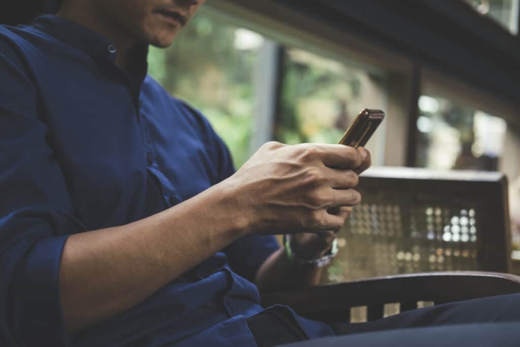 Young man using mobile phone. Using online connect technology for business, education and communication.