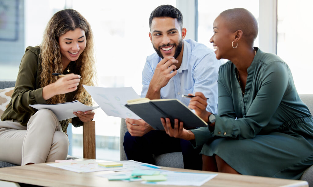 Three coworkers working on international target market research