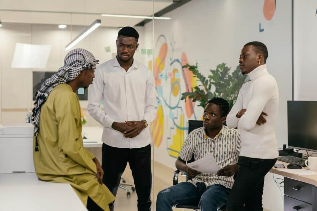 Employees having a conversation inside the office
