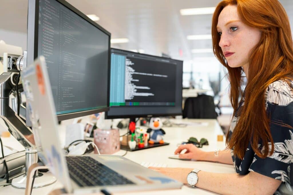 Woman coding on a computer for a language localization project