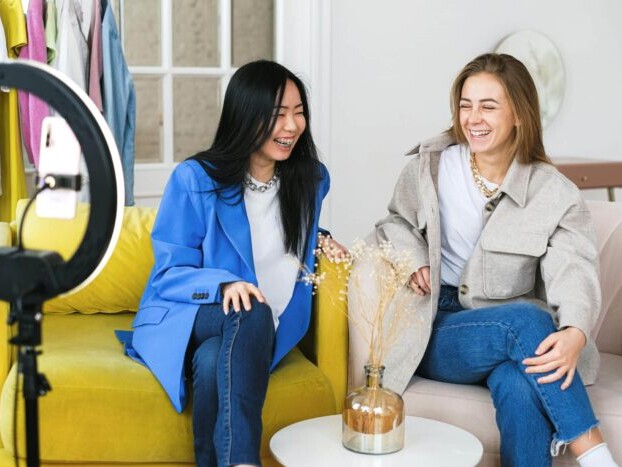 Photo of two women smiling while recording a short-from B2B video