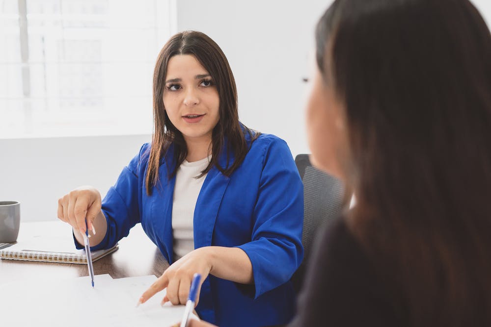 Woman Discussing Project with her Coworker