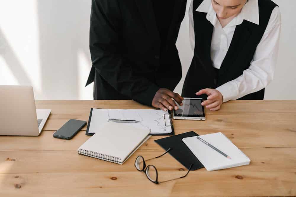 Man and woman holding a black ipad with information on the global content marketing budget