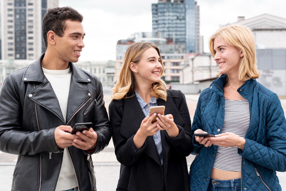 Happy friends with mobile phones