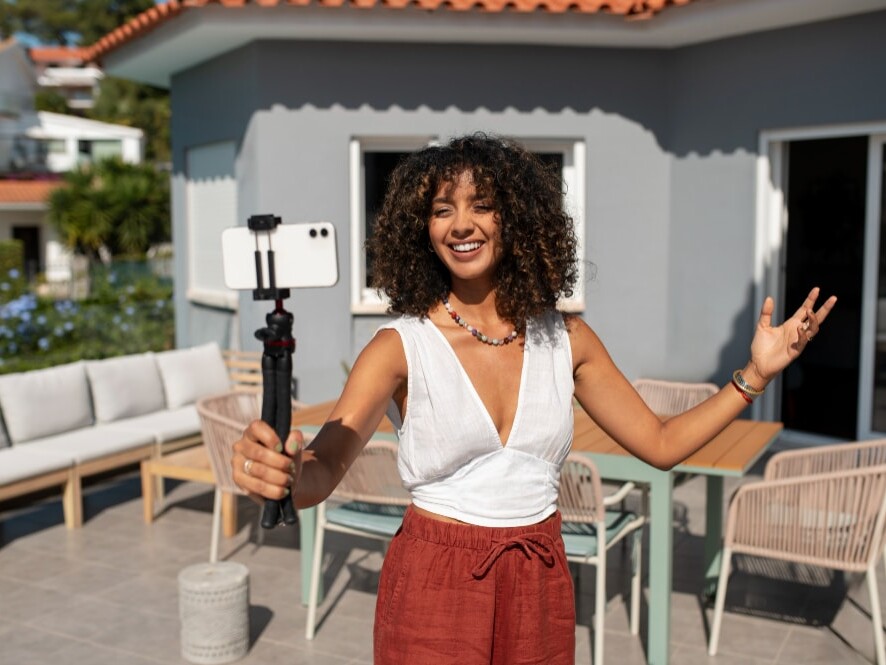Local creator holding a cellphone recording a local TikTok video