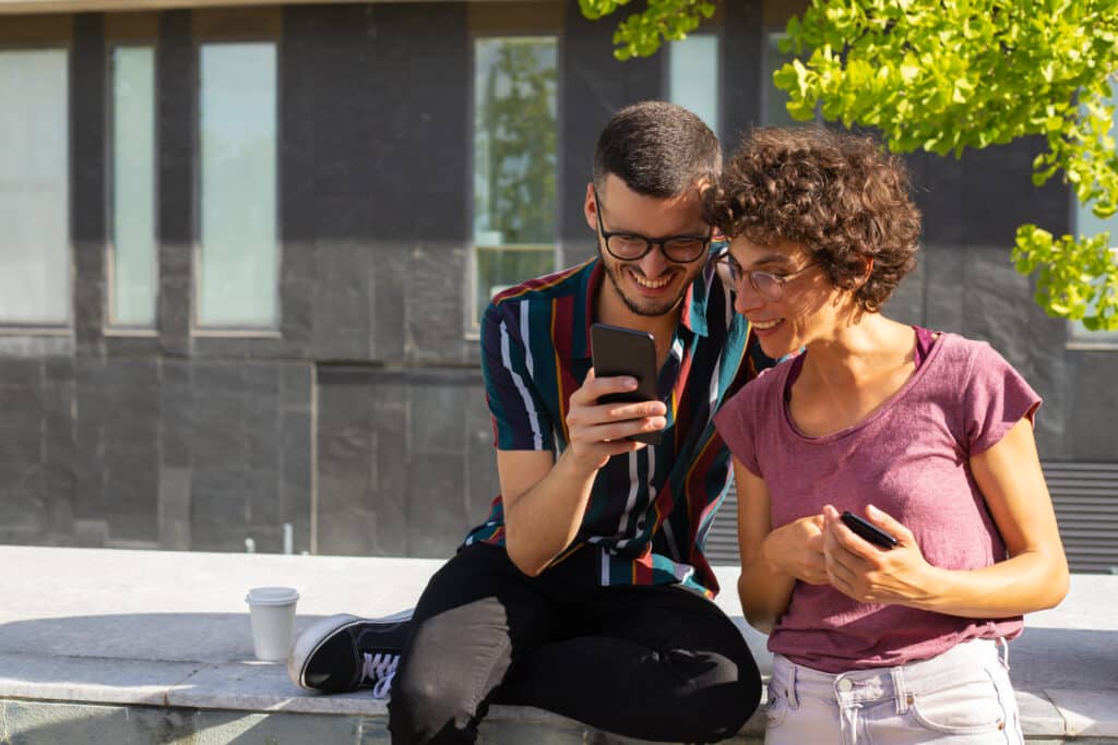 Couple watching local TikTok videos on a phone