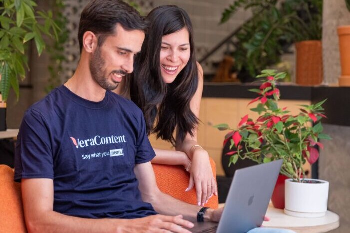 Photo of two people working on graphic design translation