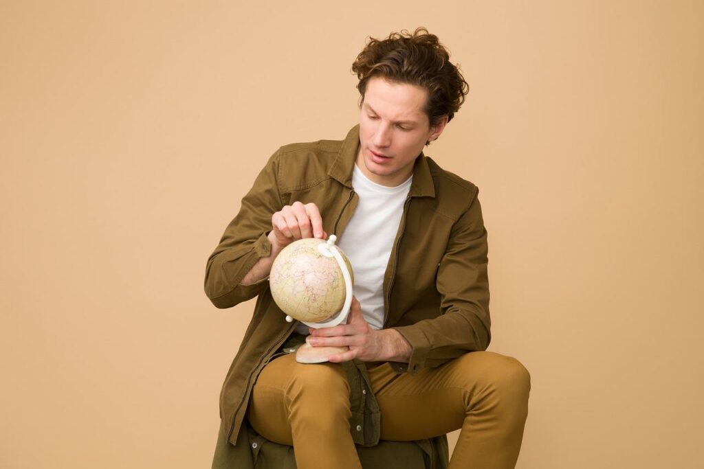 A man holding a world globe in his hand for an article discussing glocalization strategies