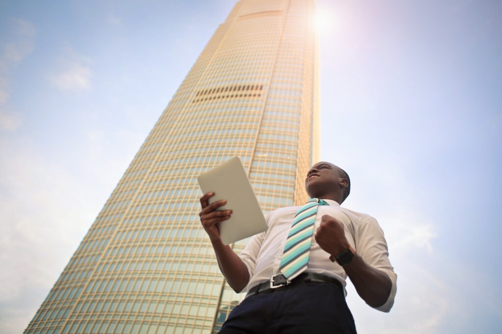 Skyscraper and a man holding tablet representing EMEA marketing