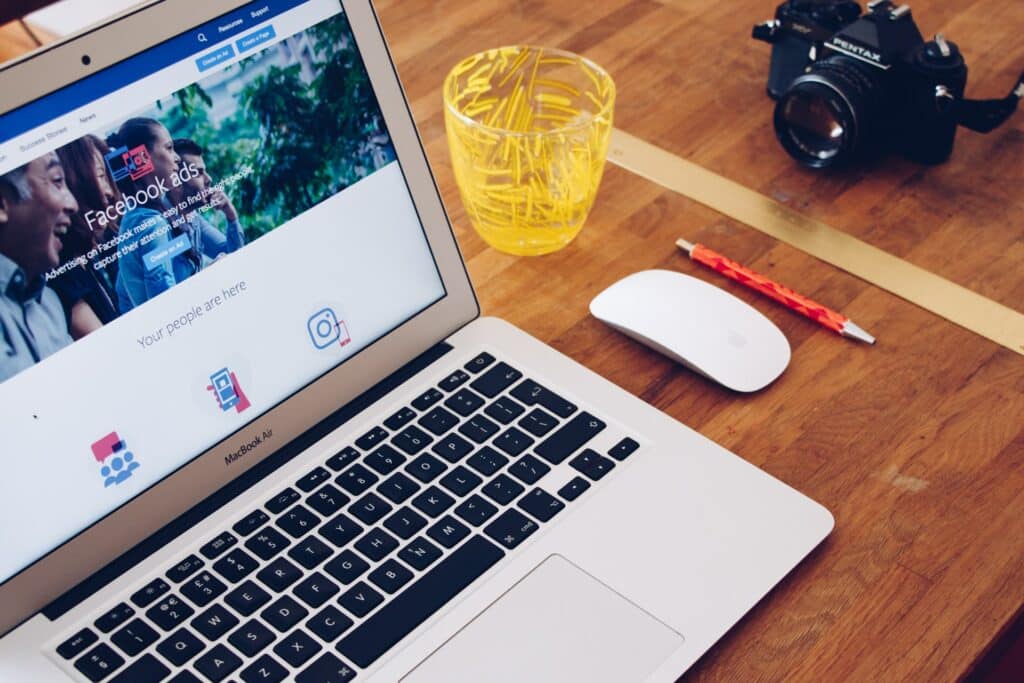 A laptop with Facebook ads showing on the screen