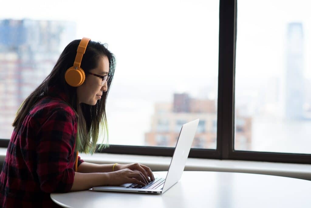Woman working on laptop using machine translation tools