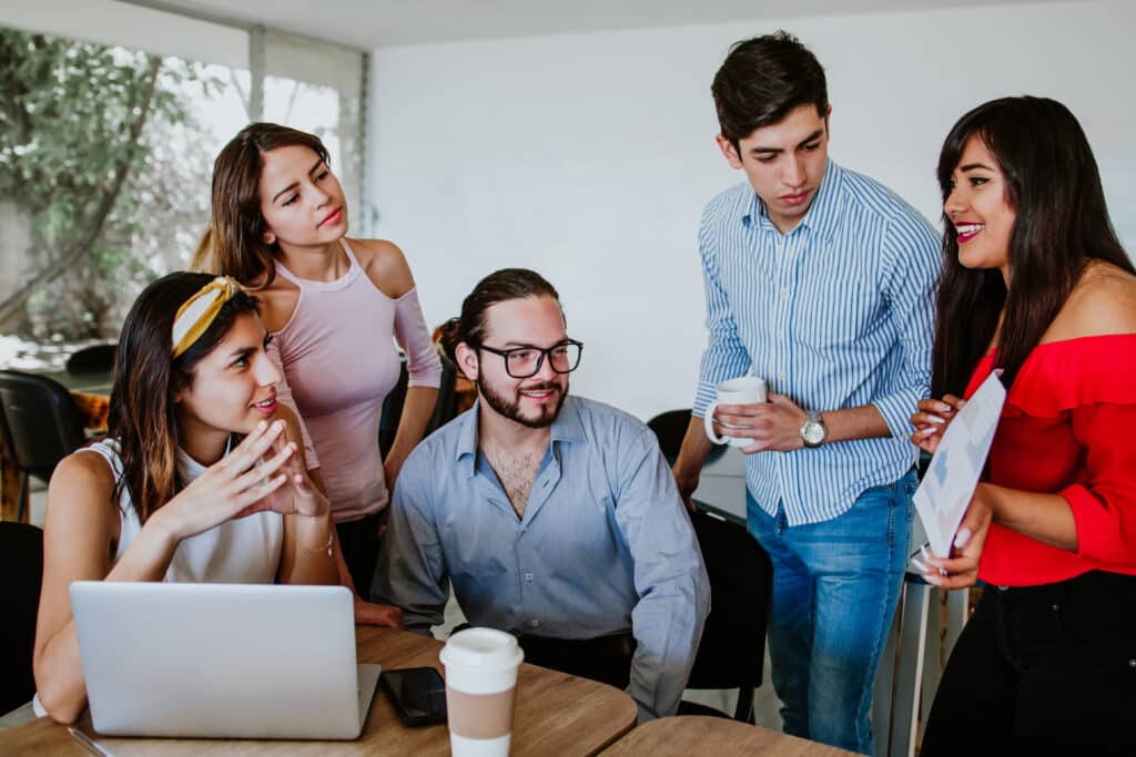 latin people at office working with computer, Group of young Mexican People in Mexico coworking
