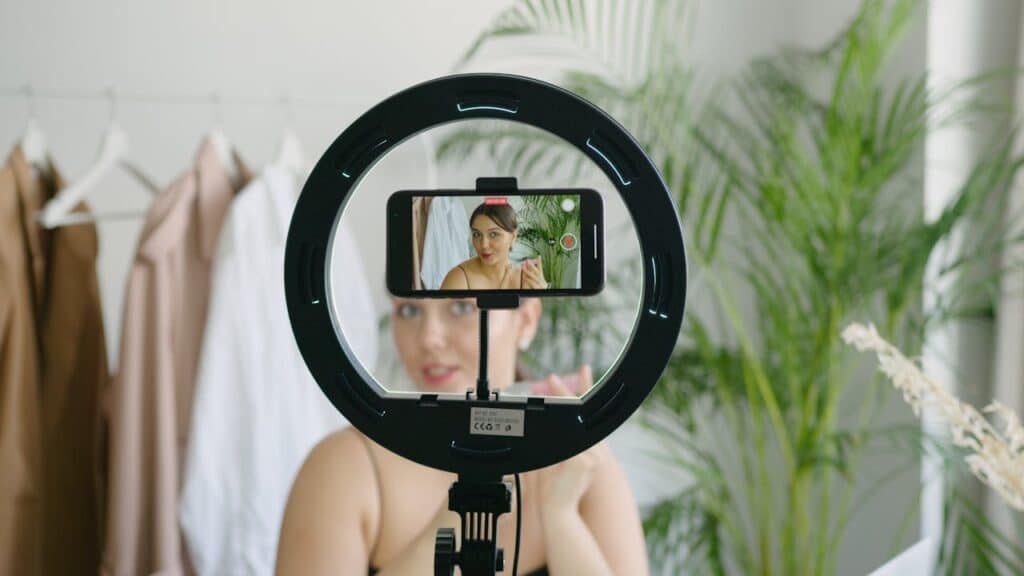 Content creator filming herself with a phone on a tripod