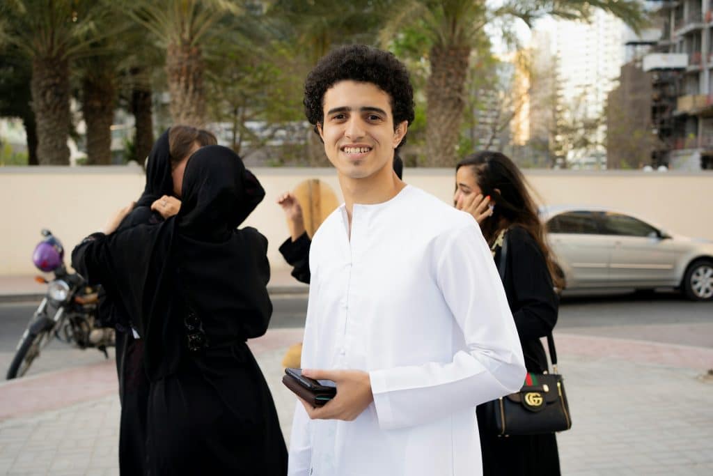 a man in a white outfit standing next to a woman
