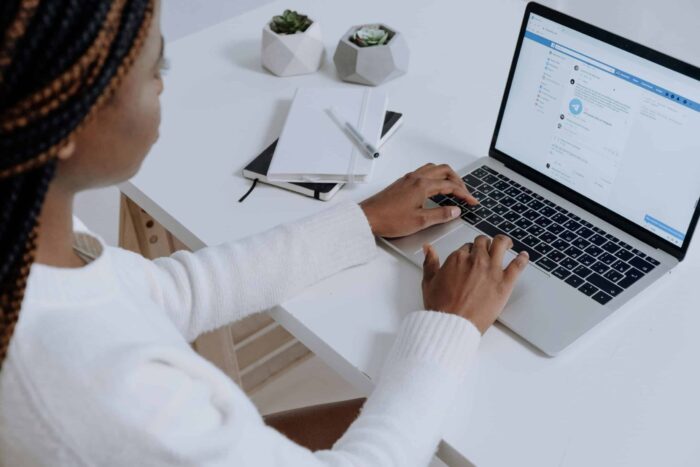 A woman looking at meta algorithm changes on her laptop