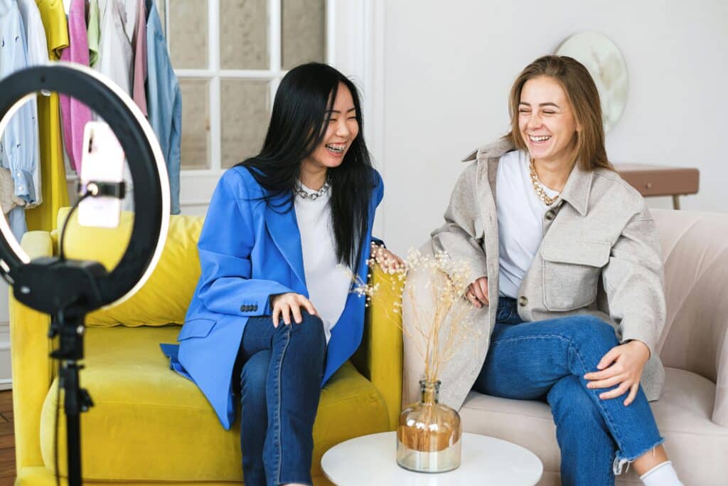 Photo of two women smiling while recording a short-from B2B video