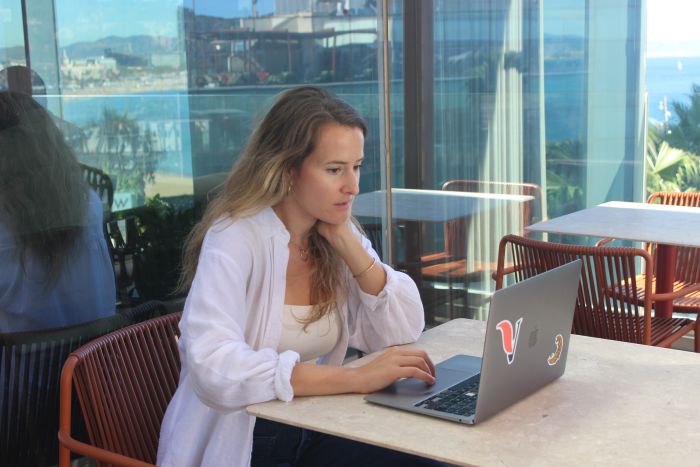 Daphne from VeraContent working on a laptop