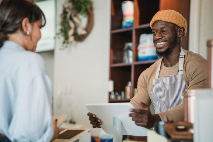 Smiling barista taking an order