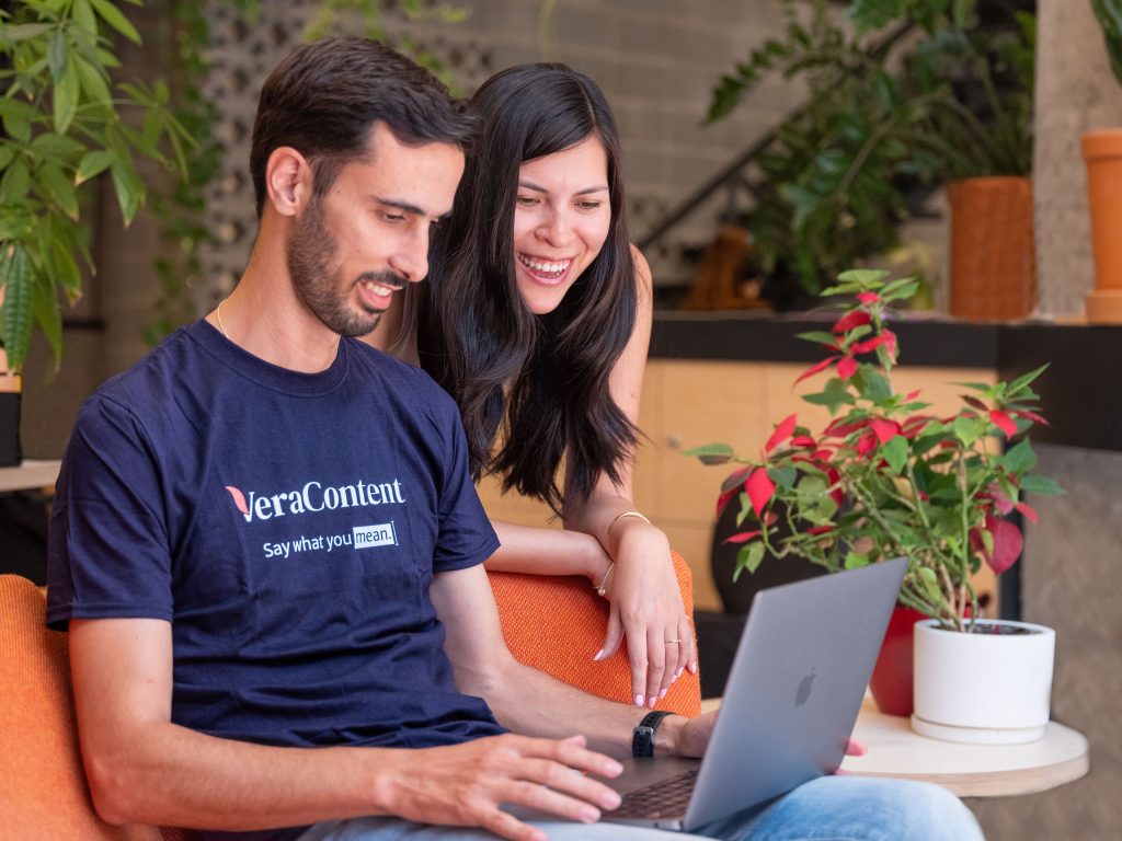 Two people working on graphic design translation