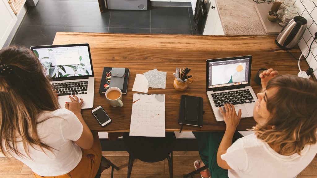 Two people working on a flagship content calendar